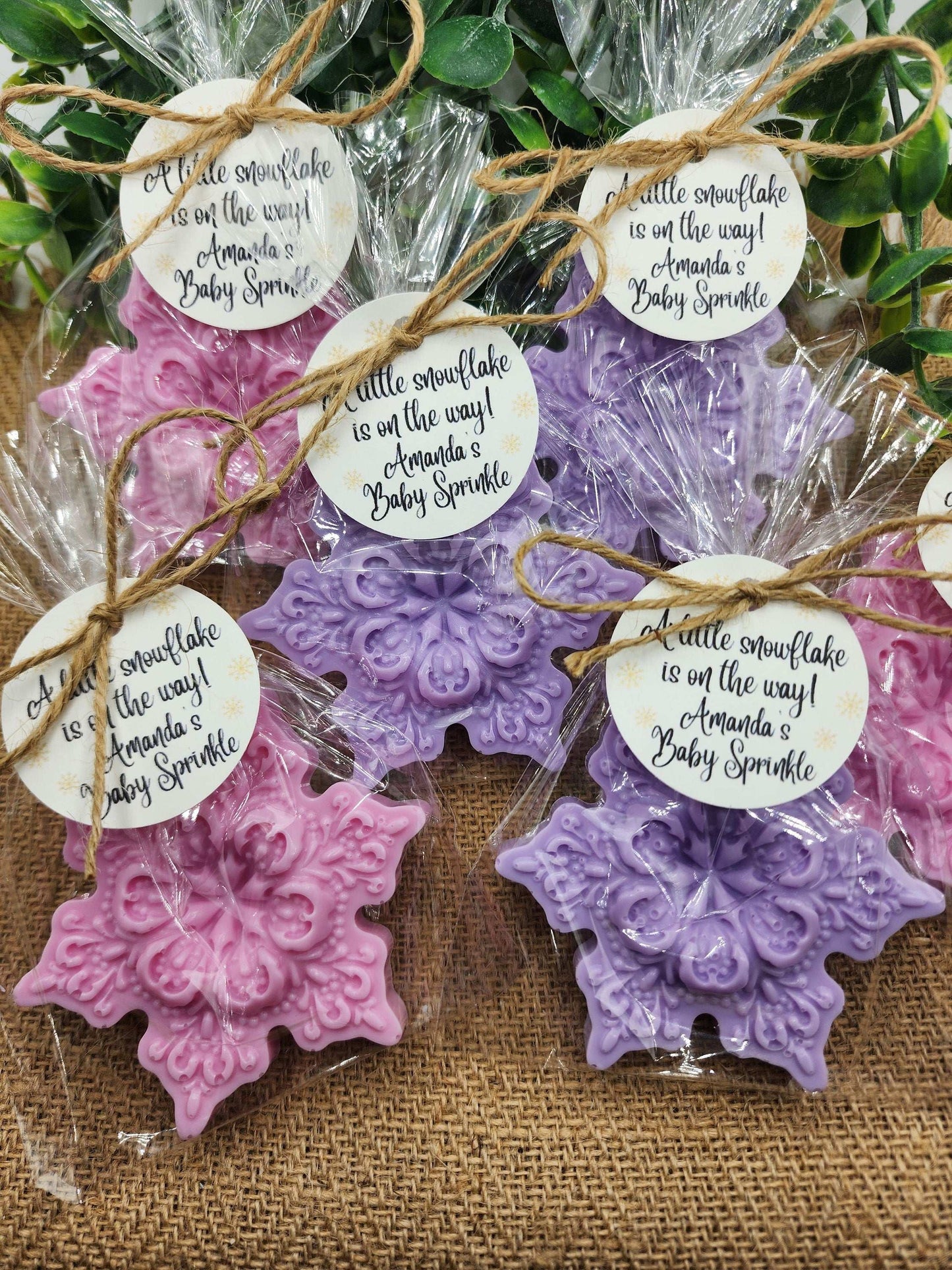 Decorative snowflake-shaped favors with personalized tags on a rustic background