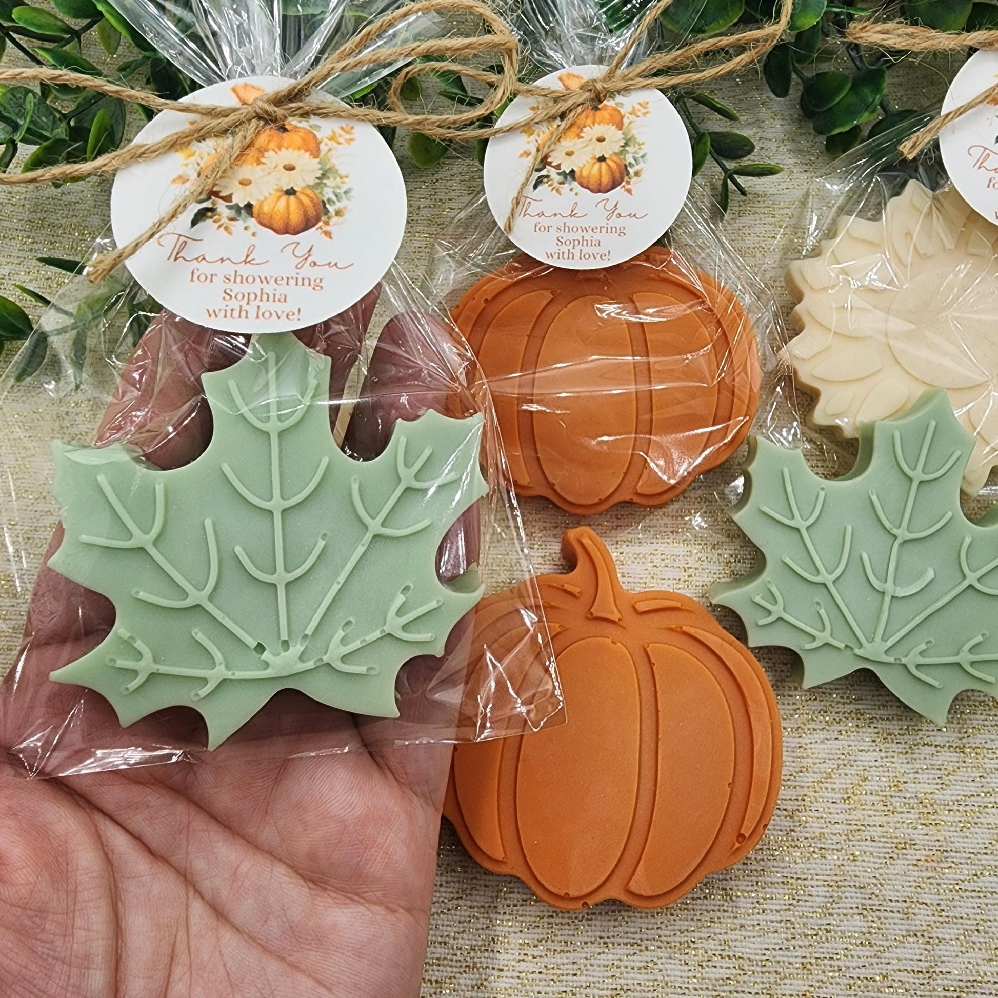 Decorative soap pieces shaped like pumpkins and leaves in clear packaging with 'Thank you' labels.